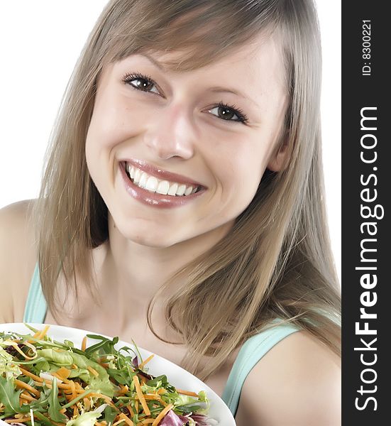 Portrait of young happy woman eating salad