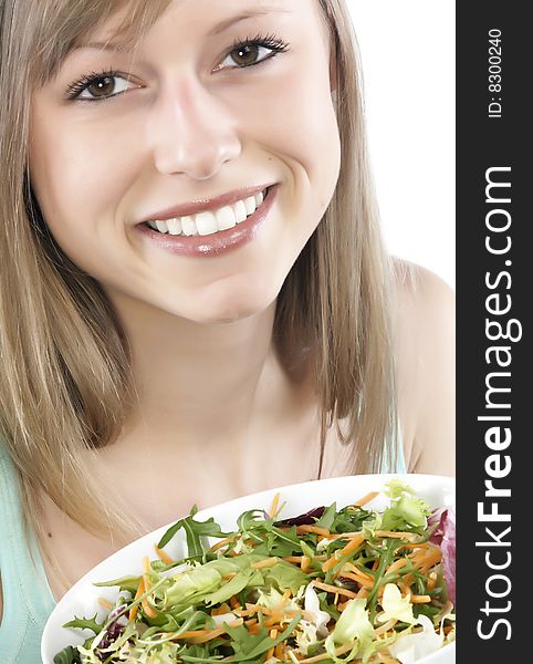 Portrait of young happy woman eating salad