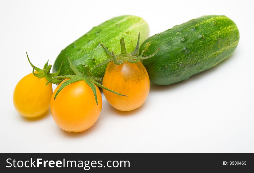 Green cucumbers and yellow tomatoes. Green cucumbers and yellow tomatoes