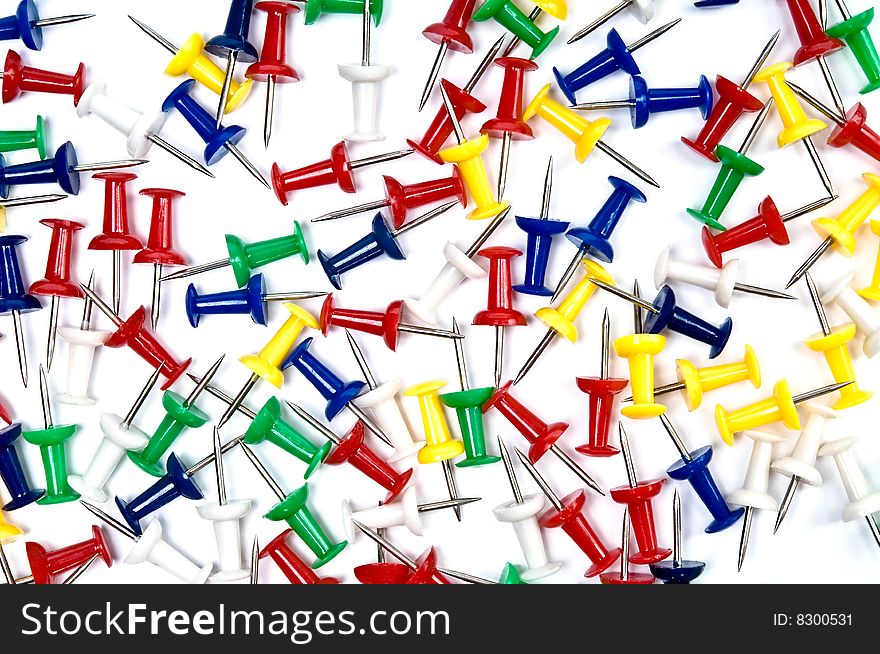 Colorful pins over the white background