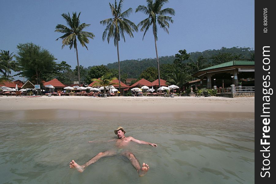 Thailand, KoChang,a man swimming in an ocean. Thailand, KoChang,a man swimming in an ocean