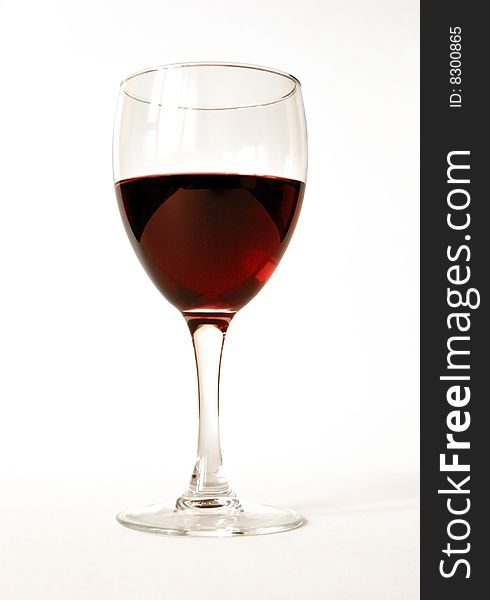 Red semisweet wine in a crystal glass on a white background. Red semisweet wine in a crystal glass on a white background