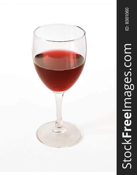 Red semisweet wine in a crystal glass on a white background. Red semisweet wine in a crystal glass on a white background