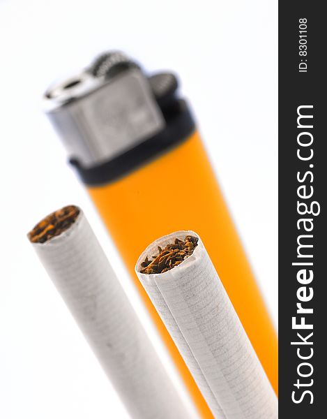 Vertical shot of two cigarettes tips with lighter in the background. Focus on foreground cigarette. White background. Vertical shot of two cigarettes tips with lighter in the background. Focus on foreground cigarette. White background.