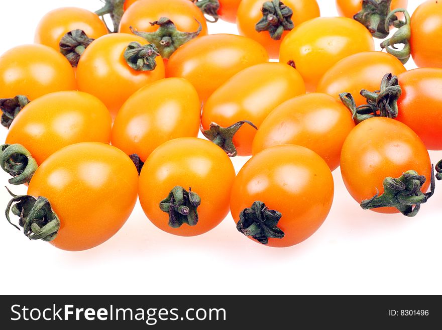 Some fresh yellow tomato on white background. Some fresh yellow tomato on white background.