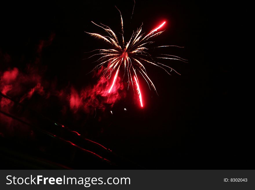 Photo of red fireworks made from the roof of the hotel