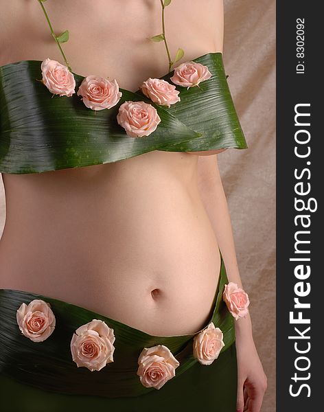 Pregnancy woman in the dressing made of a flowers. Pregnancy woman in the dressing made of a flowers