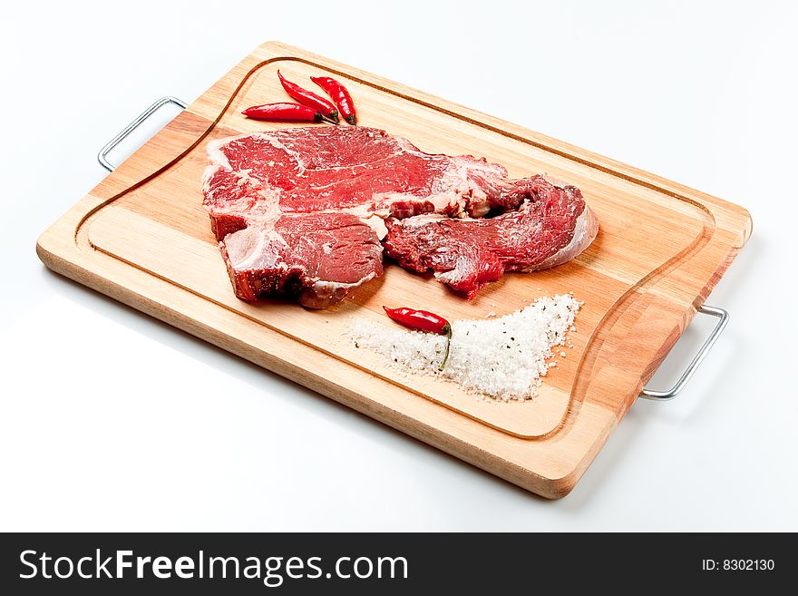Raw beef cut kown as striploin or T-Bone steak. Raw beef cut kown as striploin or T-Bone steak.