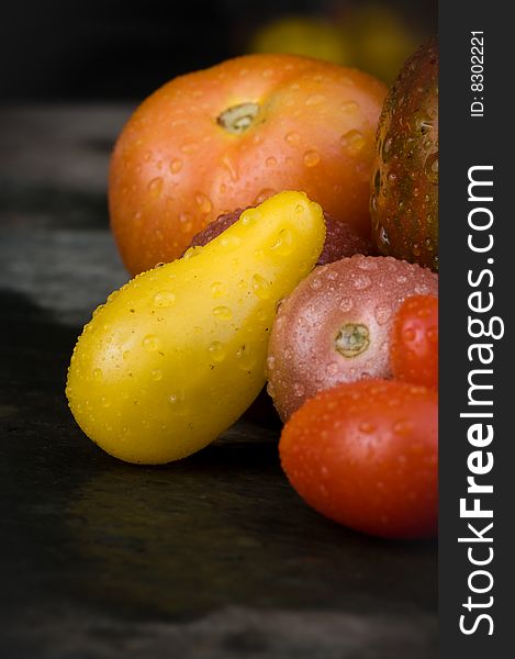 Heirloom tomatoes on dark background.  Multicolored close-up.