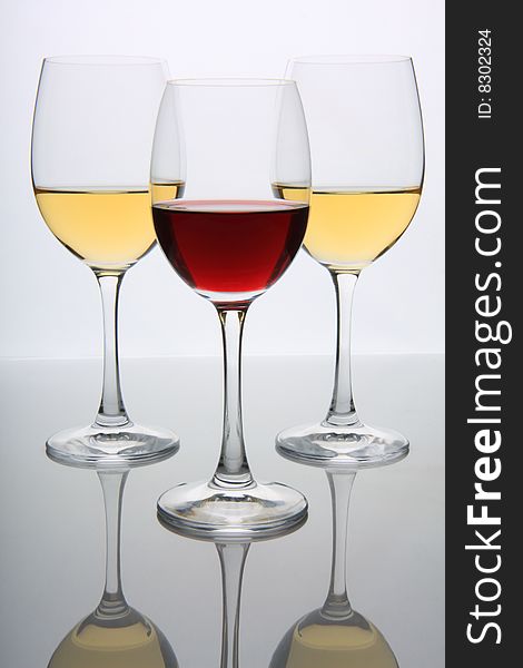 Three glasses of red and white wine. Three glasses of red and white wine