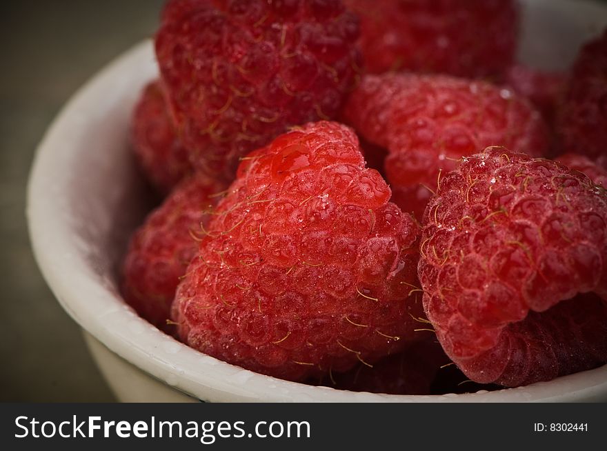 Several ripe raspberries in small bowl, close-up. Several ripe raspberries in small bowl, close-up
