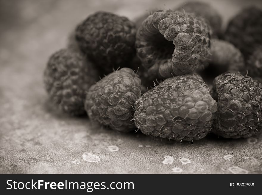 Ripe raspberries in black and white on slate background. Ripe raspberries in black and white on slate background.