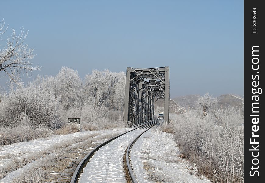 Railway trestle and bridge on a frosty winter morning with hoar frost clinging to the trees,