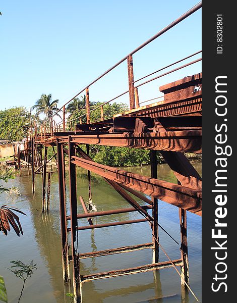 Old rusty iron bridge, in Santa Cruz del Norte, vertical. Old rusty iron bridge, in Santa Cruz del Norte, vertical