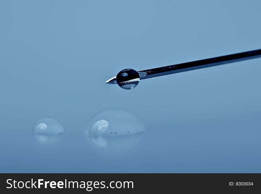 Sharp syringe needle with drops ,macro