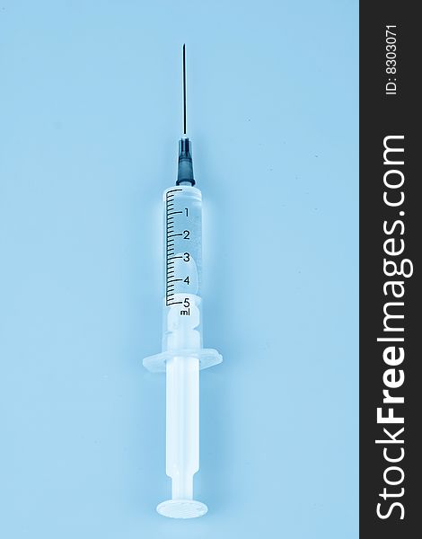 Photo of syringe in blue tones