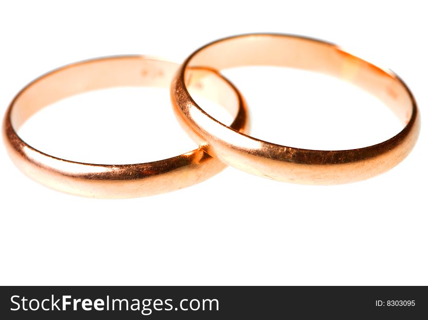 Pair of golden wedding rings isolated on white