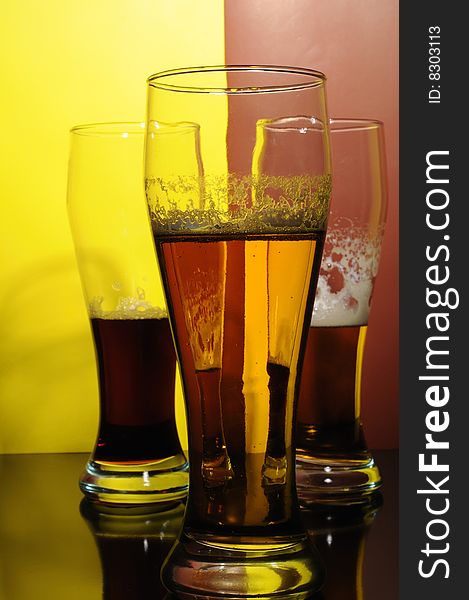 Three glasses with light and dark beer. Three glasses with light and dark beer