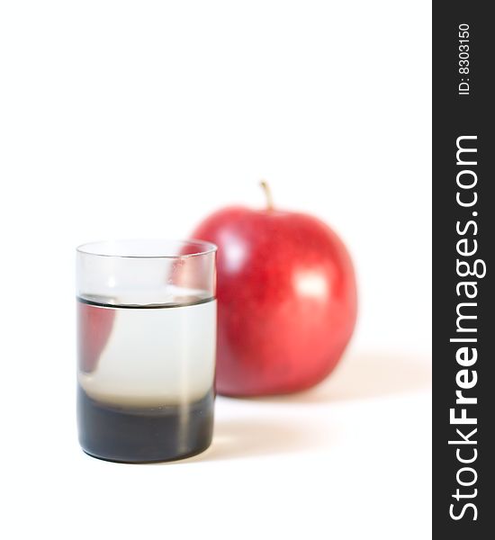 Glass with water and apple