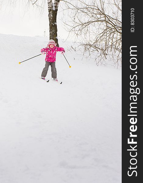 5 year old girl cross-country skiing, sliding down hill. 5 year old girl cross-country skiing, sliding down hill