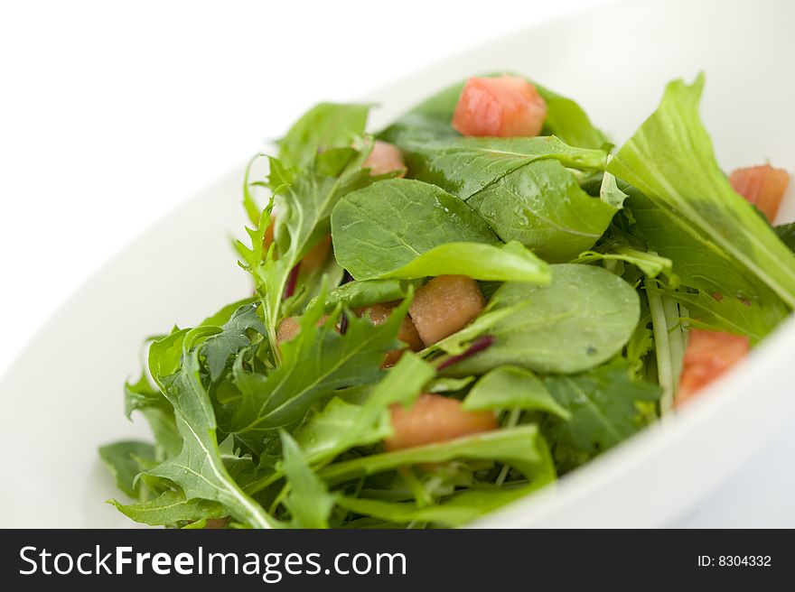 Baby leaf salad with cube cut tomato. Baby leaf salad with cube cut tomato