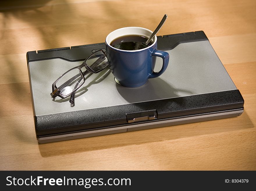 Glasses on top of laptop computer