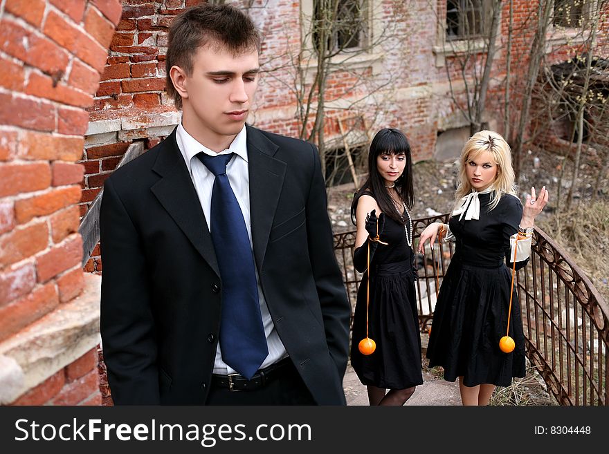 Two girl with oranges and man beside old house. Two girl with oranges and man beside old house