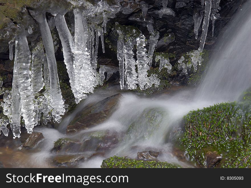 Frozen creek and icicles