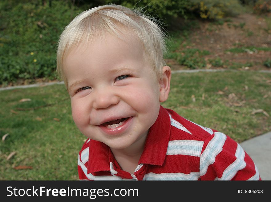 Toddler laughs and shows his chubby cheeks. Toddler laughs and shows his chubby cheeks