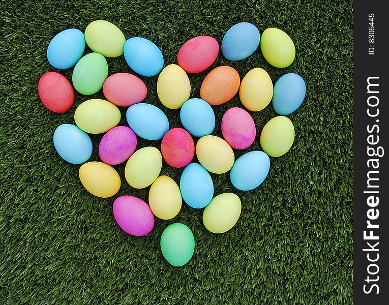 Colorful easter egg heartarrow on the green grass. Colorful easter egg heartarrow on the green grass