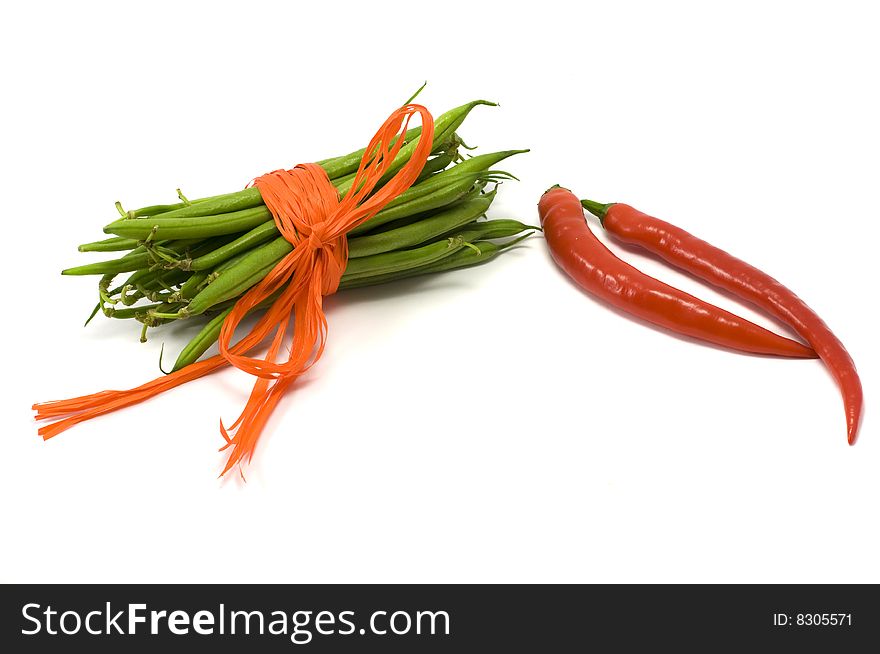 Green pods tied up orange ribbon, chilli. Green pods tied up orange ribbon, chilli