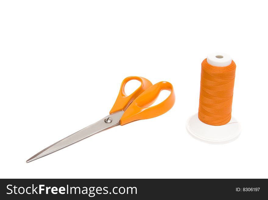 Shears and yarn on white background