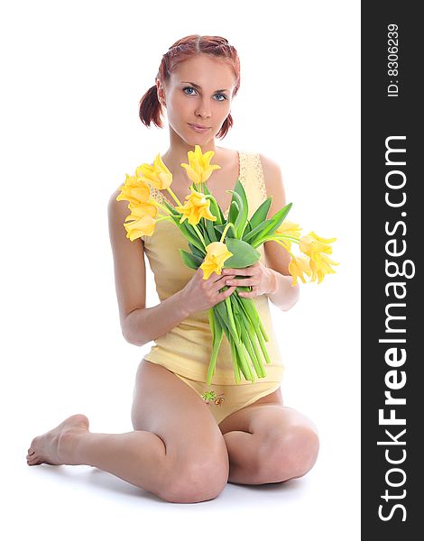 Cute young woman with yellow tulips