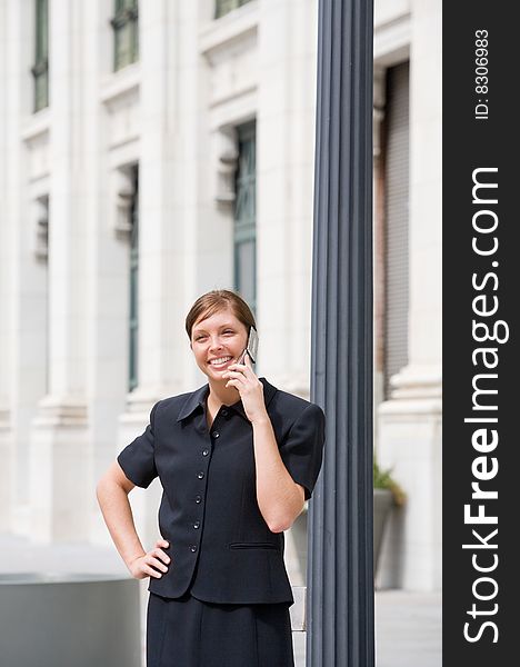 A Smiling Young Business Woman Talking on a Cell Phone