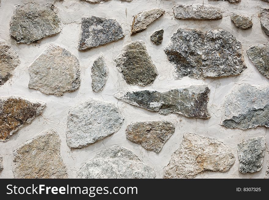 Fragment of rough wall made of irregular stones. Fragment of rough wall made of irregular stones