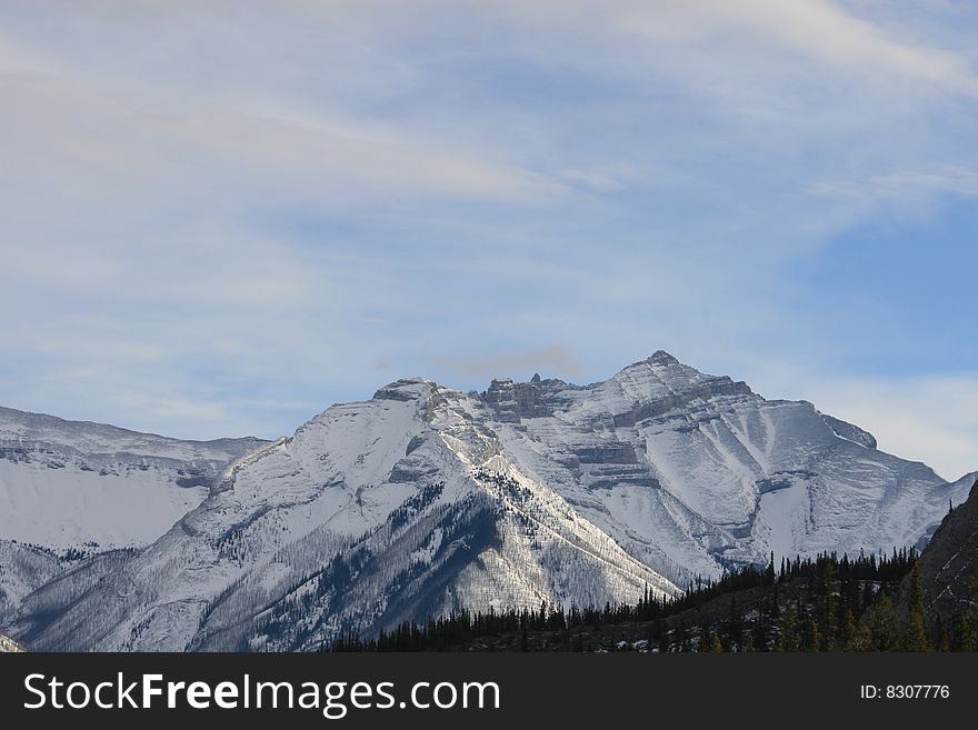 Canadian rocky mountains in winter time, snow covers the mountain range. Canadian rocky mountains in winter time, snow covers the mountain range