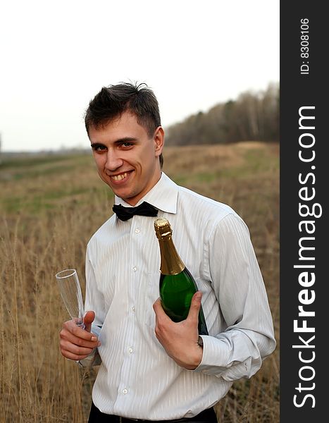 Young man with a glass and bottle of wine. Young man with a glass and bottle of wine