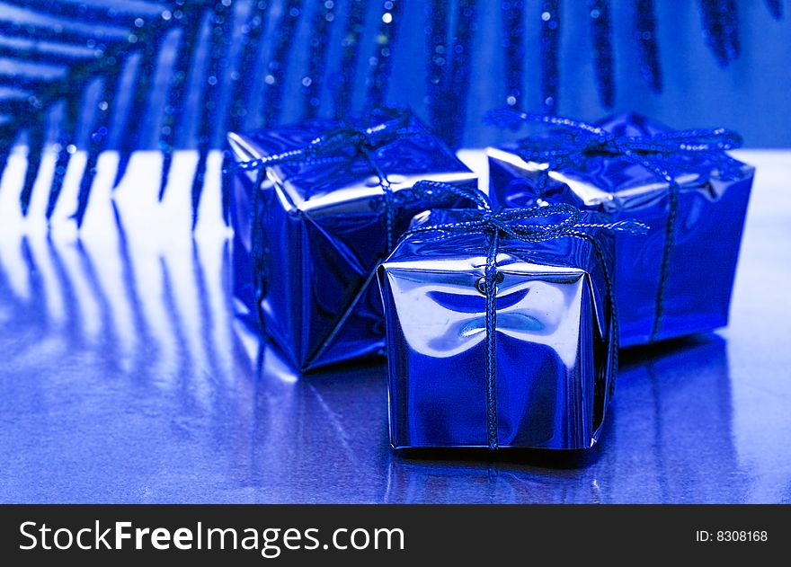 Gift boxes on blue background with leaf