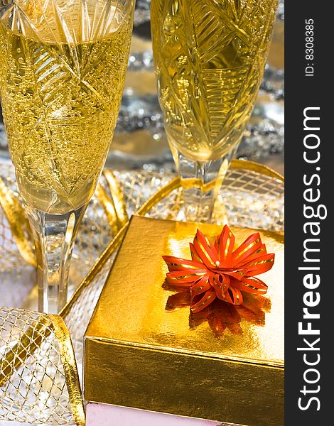 Glasses with champagne and gift box