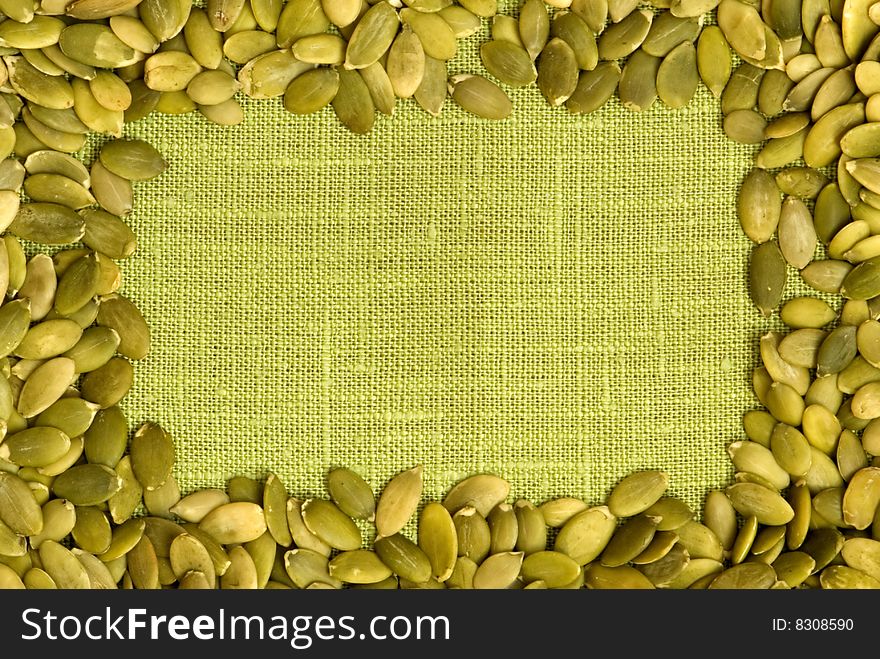 Macro pumpkin seeds frame over flax. Macro pumpkin seeds frame over flax