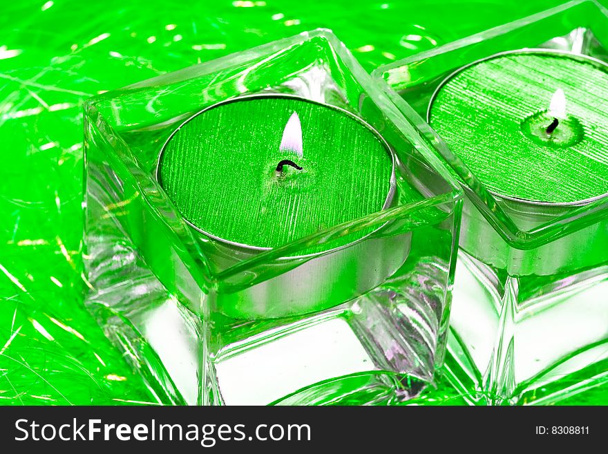 Green candles in glass with water