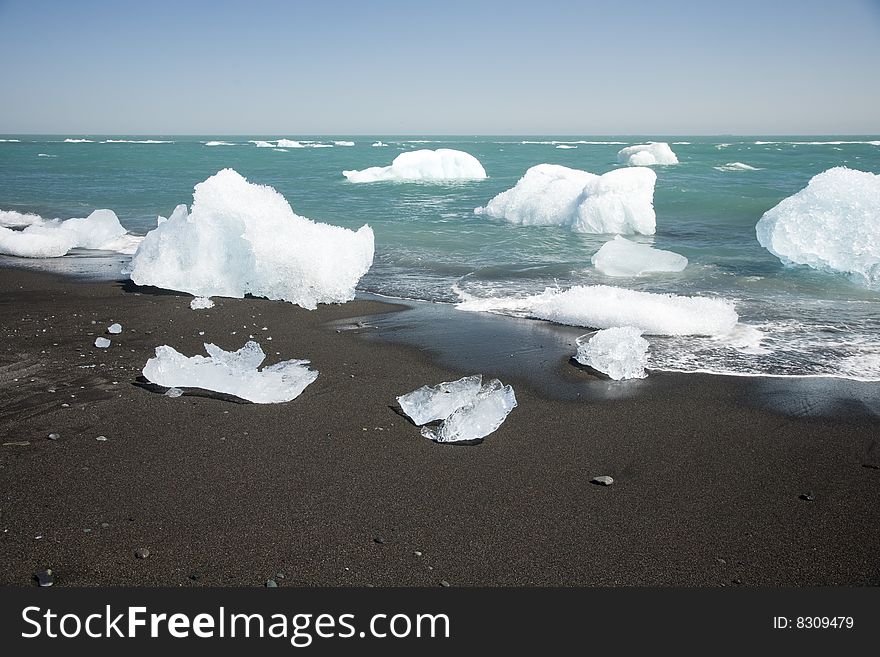 Ice from Jokullsarlon pushing into the sea and washed onto the beach. Ice from Jokullsarlon pushing into the sea and washed onto the beach.