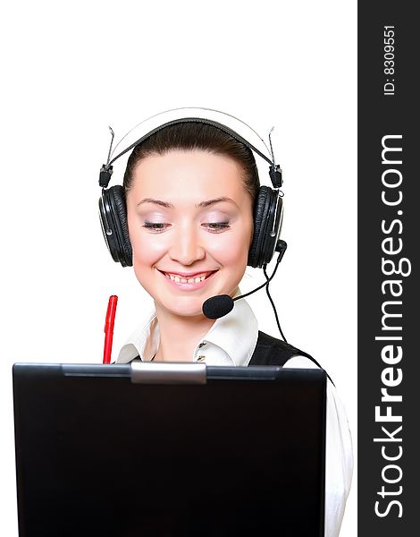 Portrait of the smiling receptionist in headset before a laptop. Portrait of the smiling receptionist in headset before a laptop