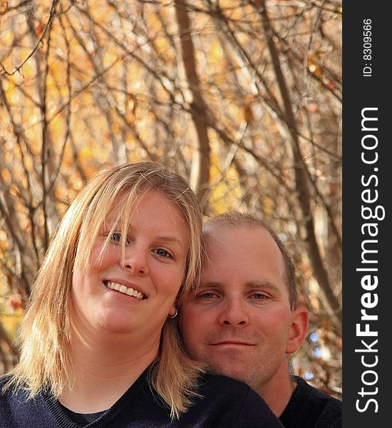 A happy young couple in the woods in Autumn