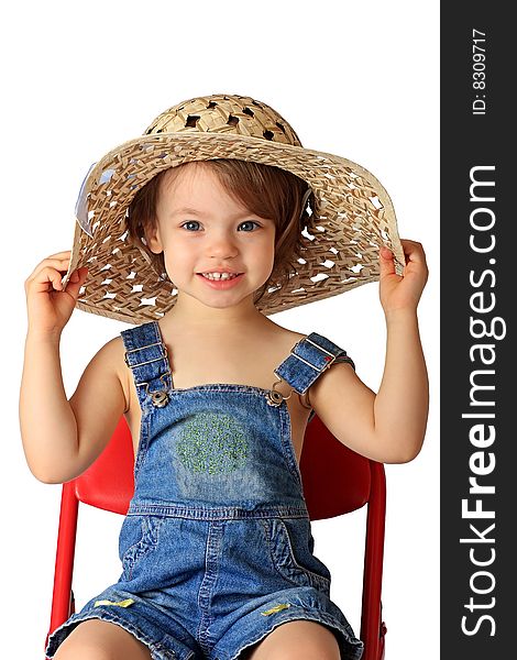 A little girl is in a straw hat. A little girl is in a straw hat.