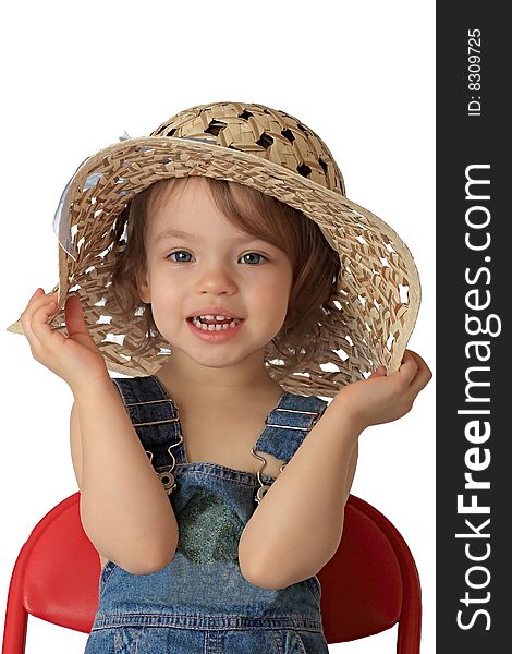 A little girl is in a straw hat. A little girl is in a straw hat.