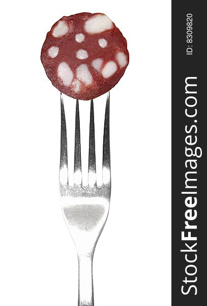 Slice of sausage on fork isolated on a white background. Clipping path. Slice of sausage on fork isolated on a white background. Clipping path.