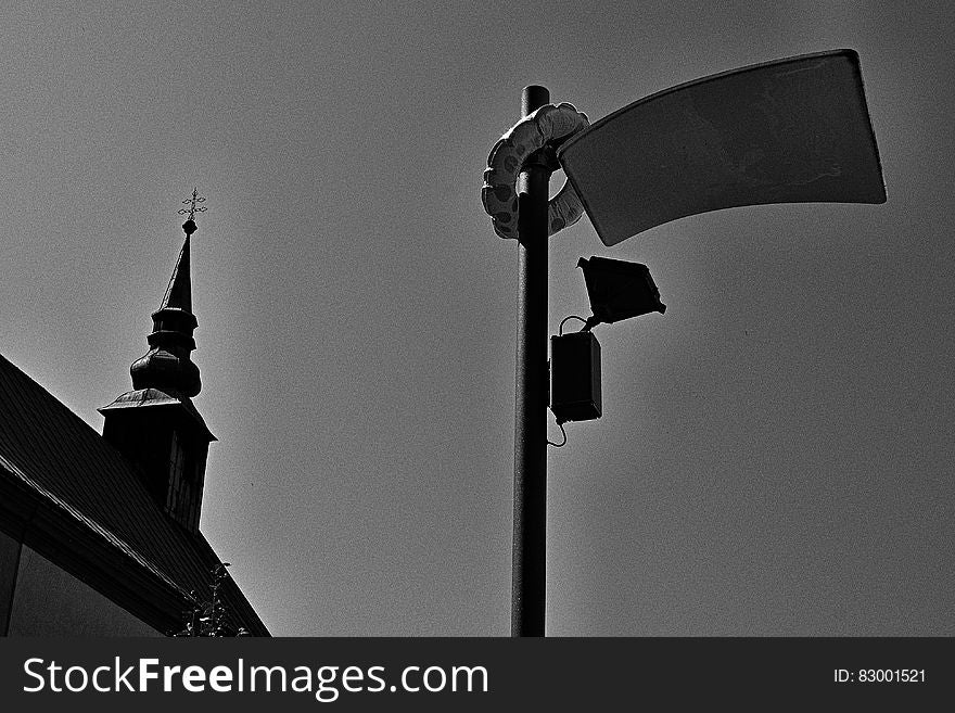 Black and white gritty urban skyline with pole and spire.