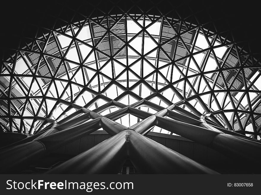 Low Angle Photography of Metal Building on Grayscale