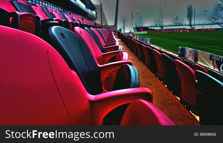 Empty seats in baseball stadium along green field. Empty seats in baseball stadium along green field.